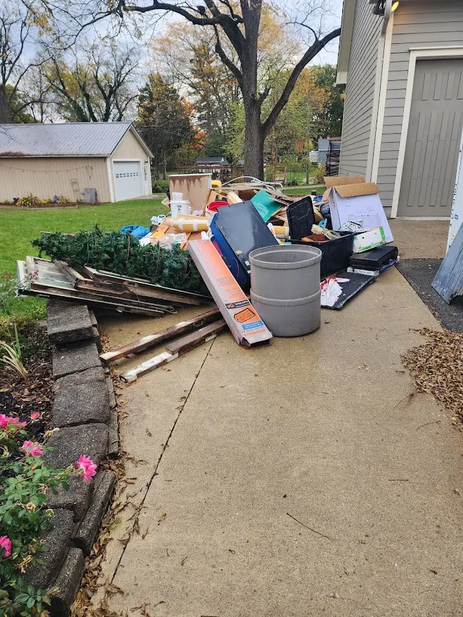 Dumpster being loaded with debris for Commercial Dumpster Rental in Dover-Foxcroft